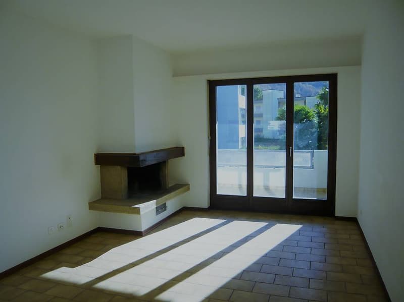 empty room, fireplace, sliding glass doors, tiled floor, white walls