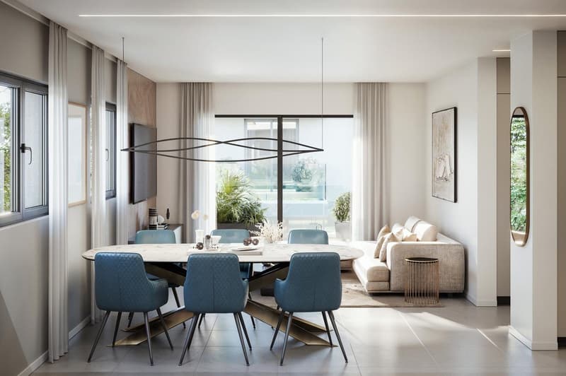 Dining room with a round table, blue chairs, a couch, and a glass door leading to a patio