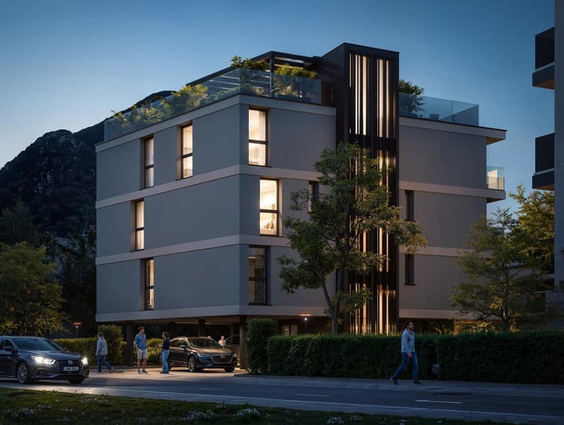 Modern multi-story building with a rooftop terrace, glass windows, and a glass-enclosed balcony on the top floor.