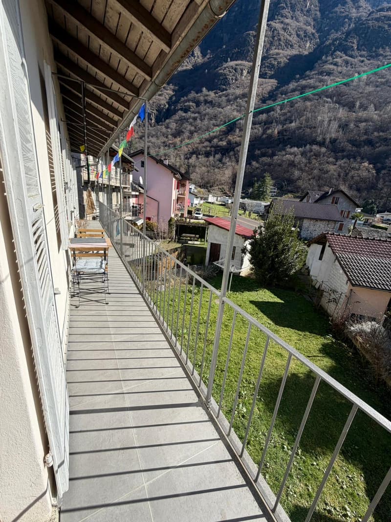 Terrace with metallic railing, tile flooring, with view of mountain