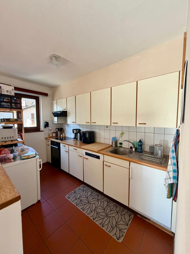 modern kitchen, white cupboards, brown tiled floor, sink, dishwasher, refrigerator, cooking appliances