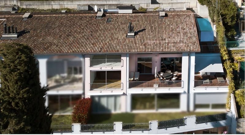 4 story house, brown roof, multiple balconies, raised ground floor