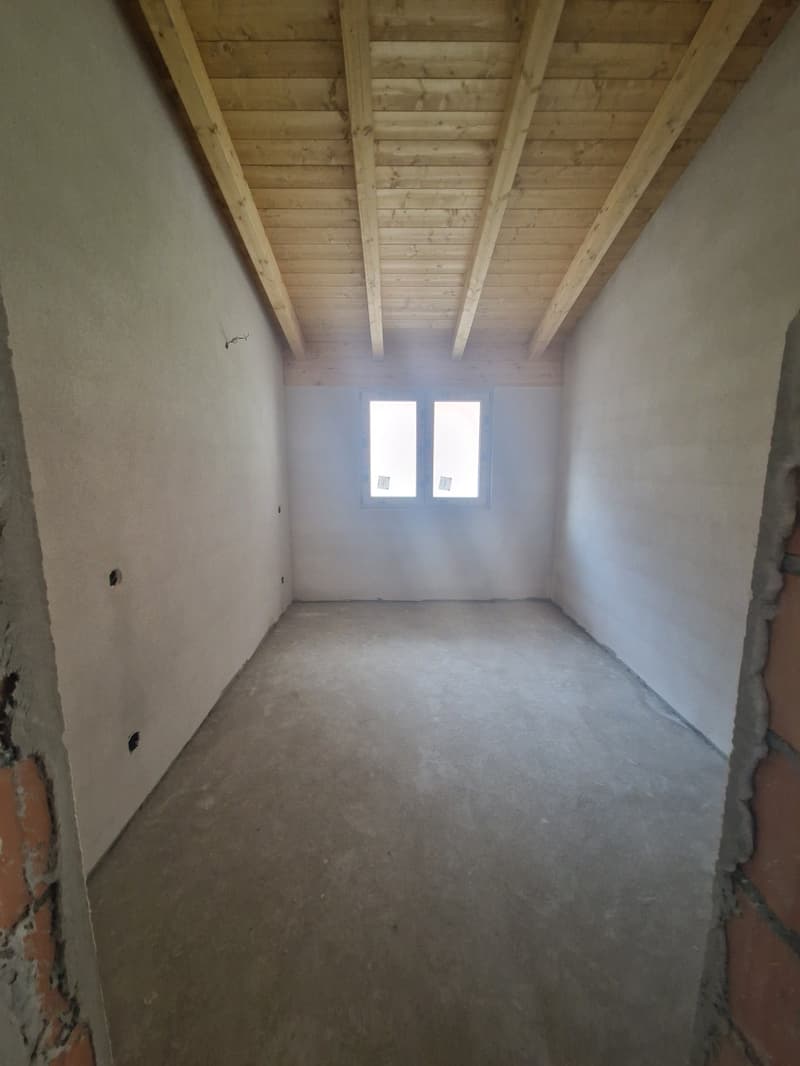 empty room, wooden ceiling, white walls, concrete floor, two windows