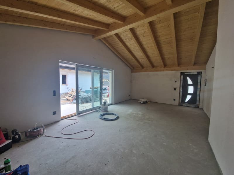 empty room, wooden ceiling, sliding glass door, concrete floor, bucket, cables