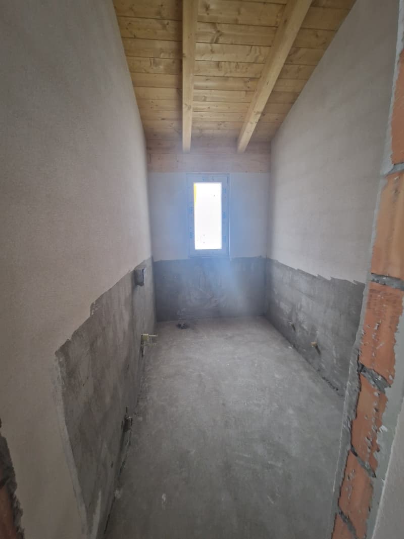 empty room, wooden ceiling, concrete floor, small window