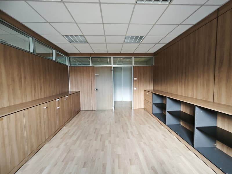 empty room, wooden walls, wooden floor, built-in cabinets, glass windows, open door