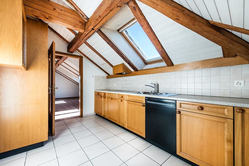 Modern rustic kitchen with wooden countertops, stainless steel sink, wooden cabinets, dishwasher, white tiled flooring
