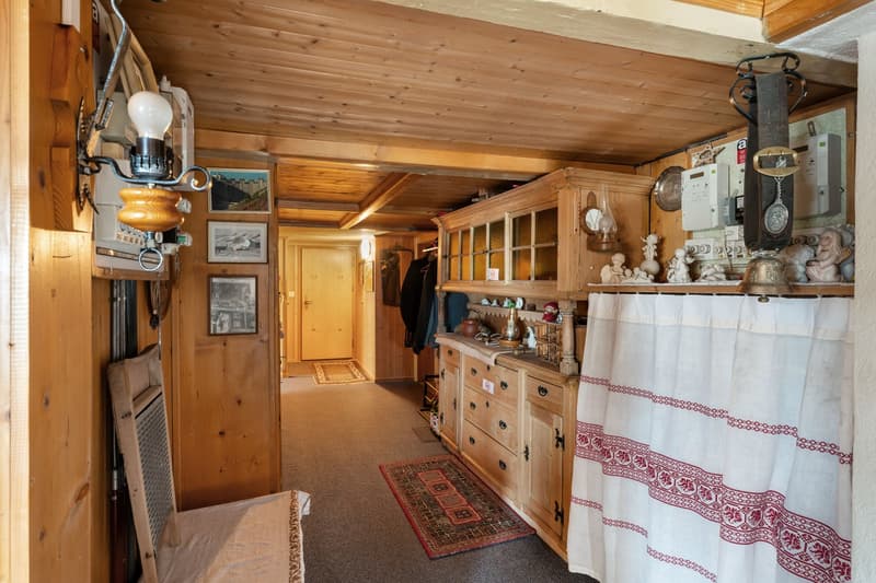 wooden walls, wooden floor, wooden cabinet, rug, lamp, door, picture frames, curtain