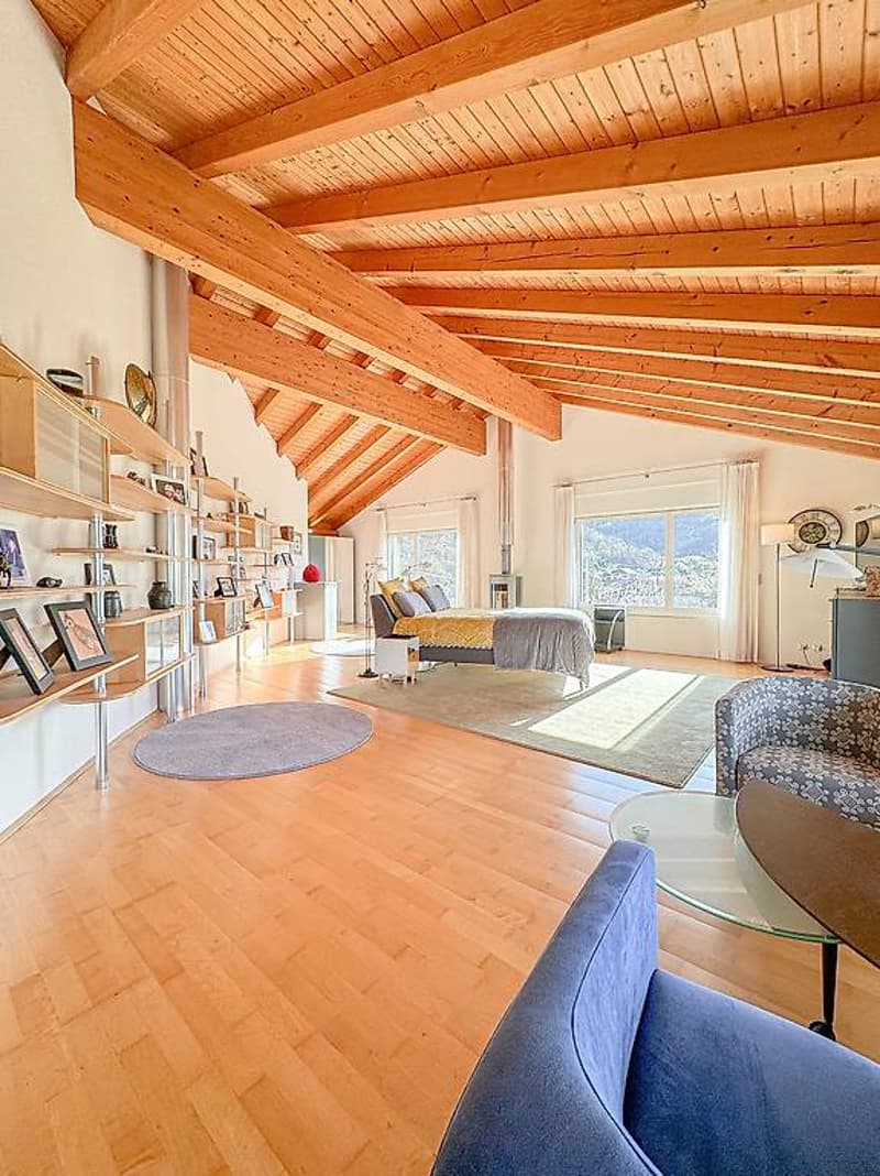 Open loft style, hardwood floors, wooden ceiling beams, daylight windows, cozy bedding