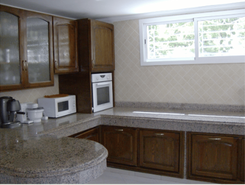 Kitchen: granite countertops, wooden cabinets, oven, microwave, sink