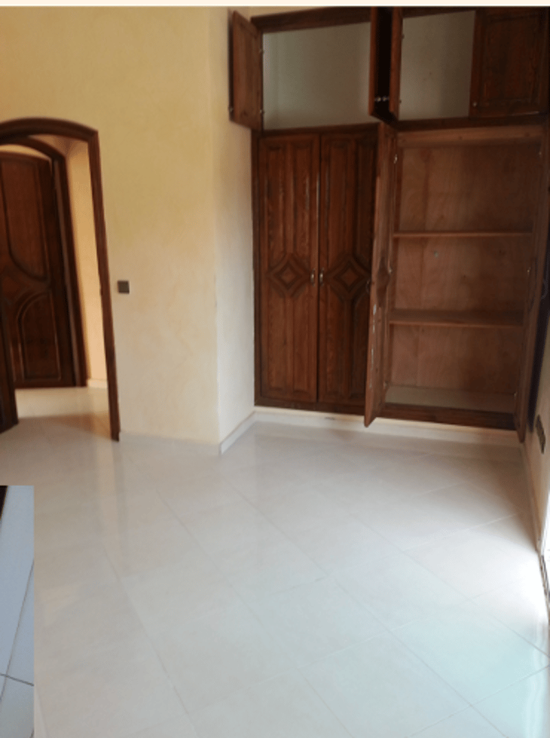 tiled floor, two wooden cupboards, arched wooden door