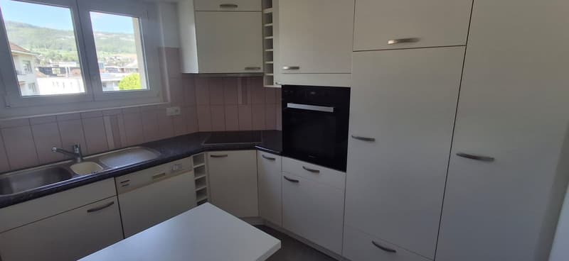 kitchen with sink, built-in oven, dishwasher, countertop, cabinets, window