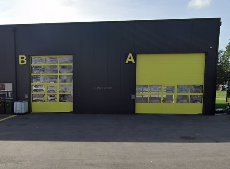 black building with 2 yellow garages