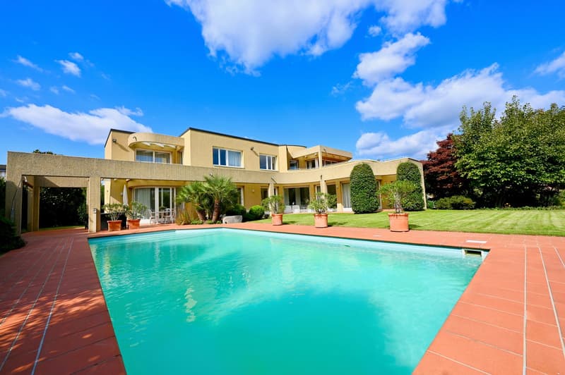 Large villa with pool, lawn, well-kept garden, yellow exterior, red roof, many windows