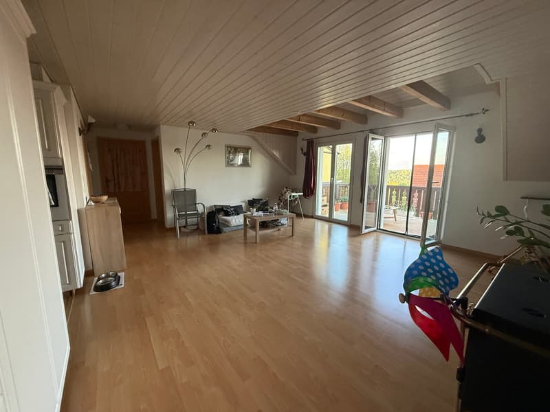 wooden floor, sliding glass doors, balcony, wooden table, floor lamp, wooden chair, white cabinets, white walls