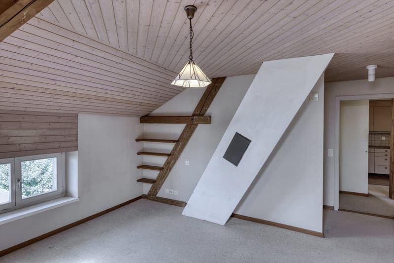 empty attic room, wooden ceiling, white walls, wooden ladder, window, slanted wall