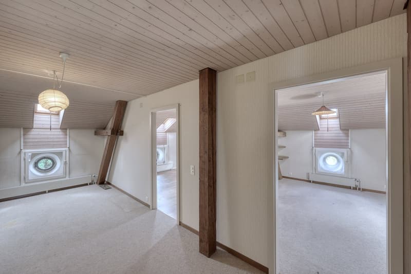empty room, wooden ceiling, carpeted floor, two windows, two doors, wooden beams