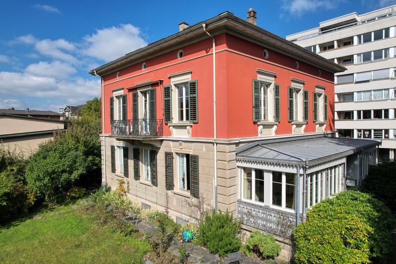 3 story house, red exterior, white windows, balcony, glass conservatory, garden