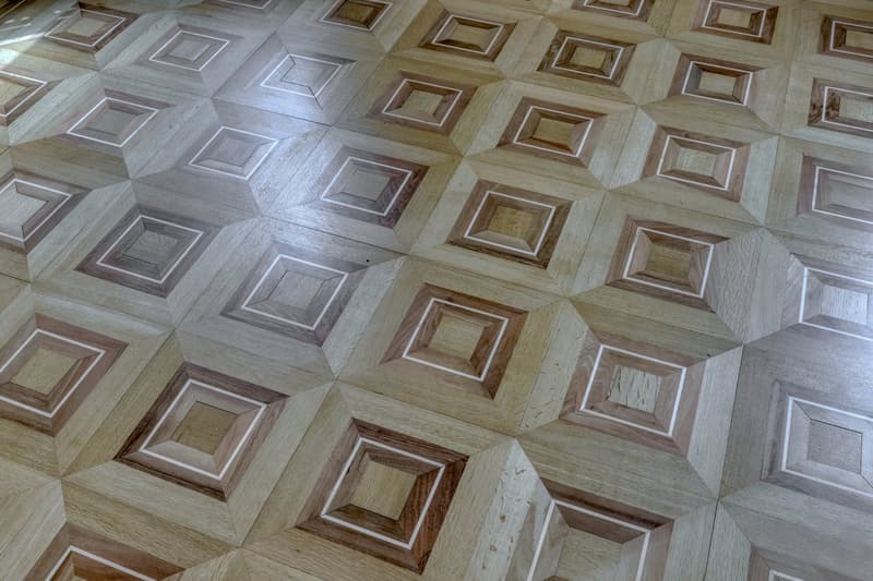 Parquet floor with geometric pattern, wooden tiles, light color, clean