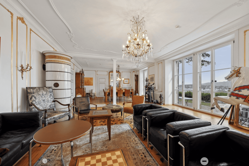 modern furniture, white walls, chandelier, wooden floor, fireplace, glass doors, view to the outside