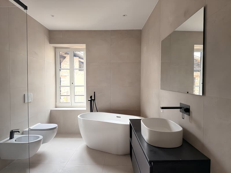 modern bathroom, bathtub, sink, mirror, windows, tile floor, glass shower enclosure, toilet