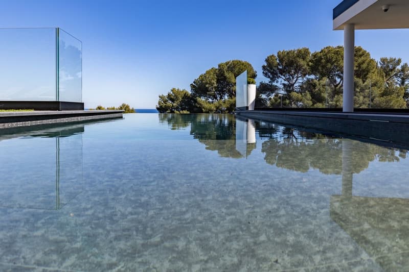 infinity pool, glass railing, trees, ocean view