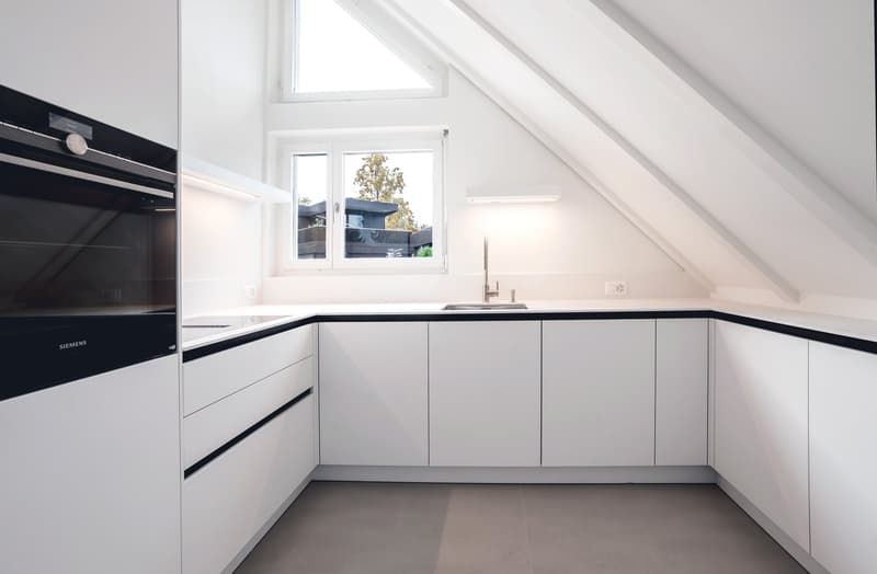 modern kitchen, white cabinets, stainless steel appliances, tiled floor, skylight window
