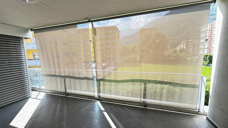 Floor to ceiling windows with a balcony view of the building's surroundings