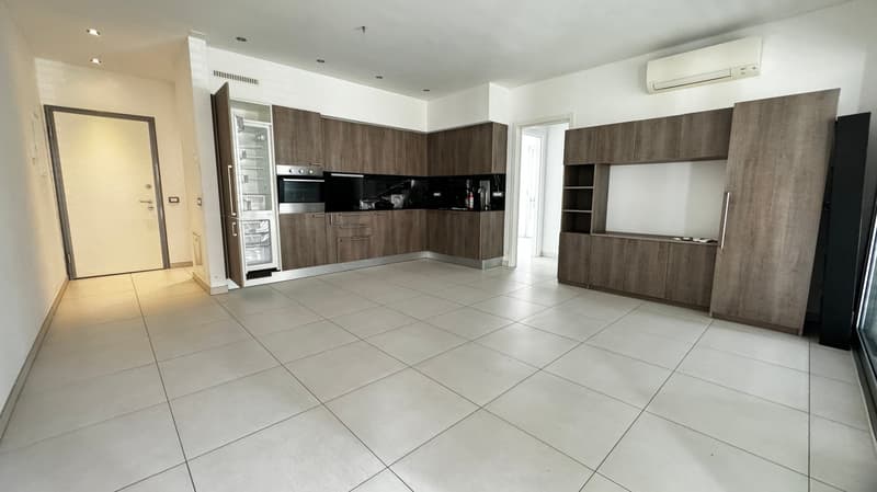 tiled floor, modern wooden cabinets, open refrigerator, oven, kitchen countertop, sink with faucet, air conditioning unit