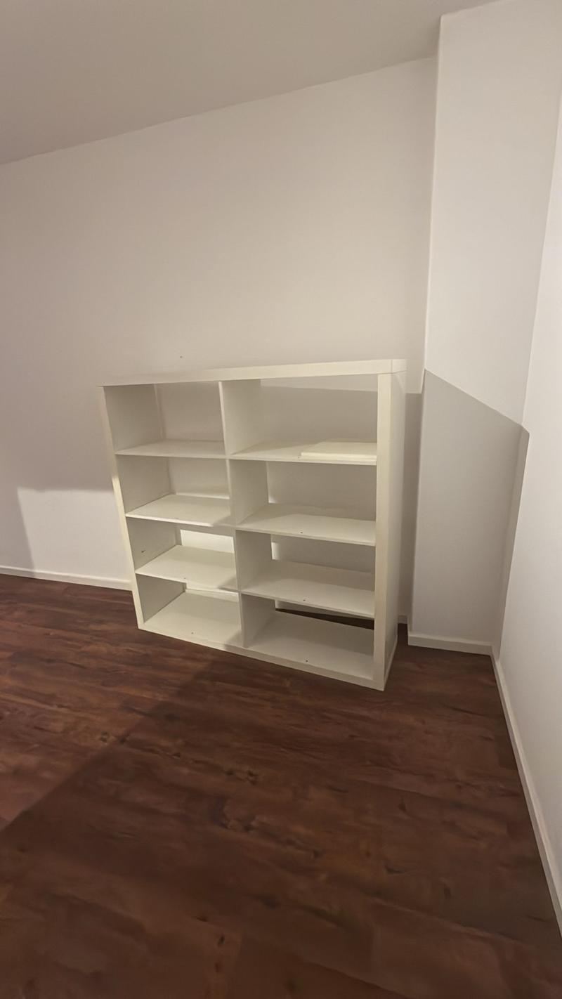 white wooden shelf against the wall, wooden floor