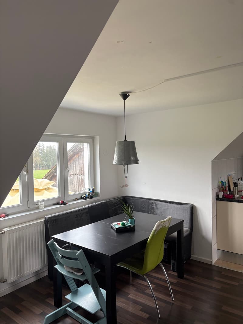 Dining area, dining table, high chairs, sofa, radiator, windows, lamp