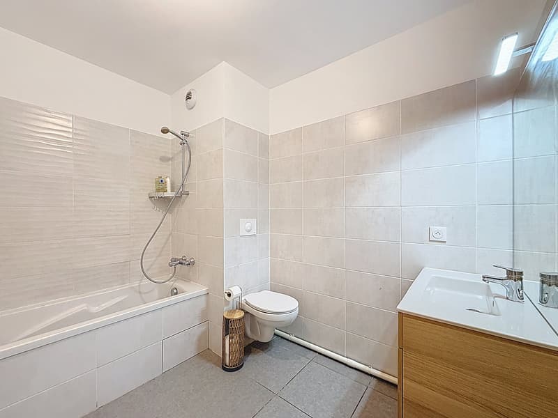 Bathroom with bathtub, toilet, sink, and shower