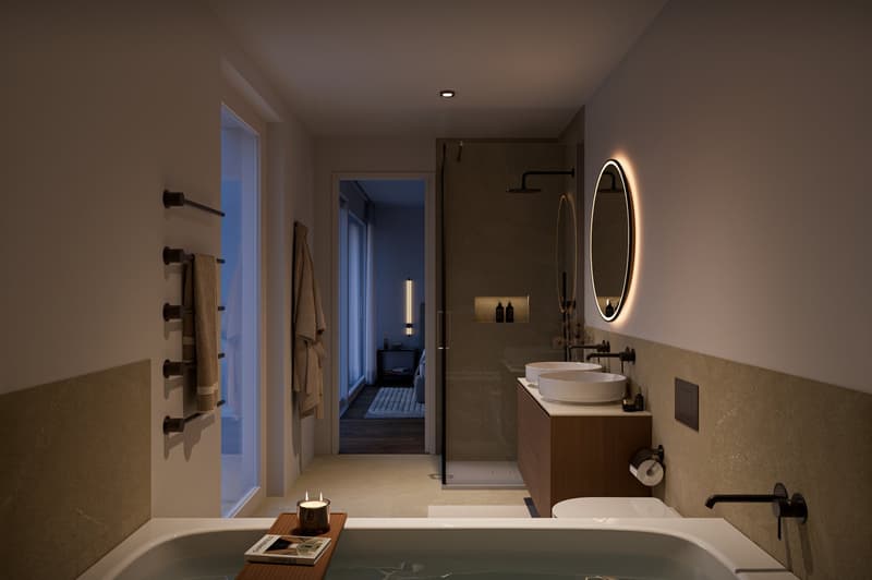 large bathtub, dual sinks, modern vanity, glass shower enclosure, illuminated mirror, towel racks
