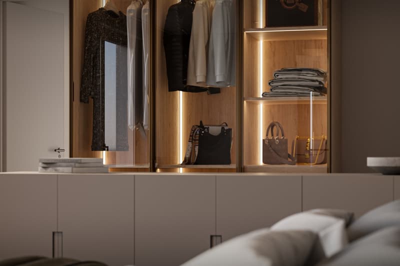 walk-in closet with glass doors, built-in LED lighting, folded clothes, handbags on shelves, a large white storage cabinet