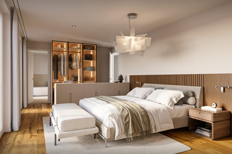 Large bedroom with wooden floors, modern decor, a white bed, a built-in wardrobe, and a bedside table.