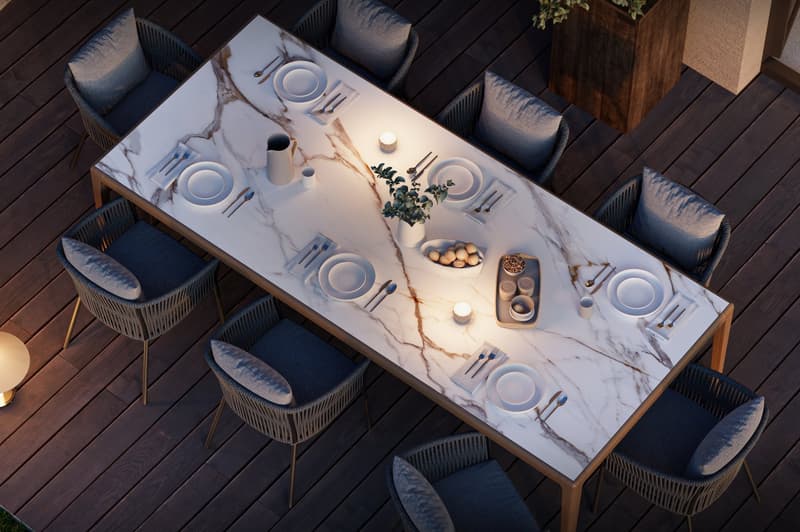 marble table, modern chairs, wooden floor, plates, cutlery, candles, wooden tray, flowers, lamp