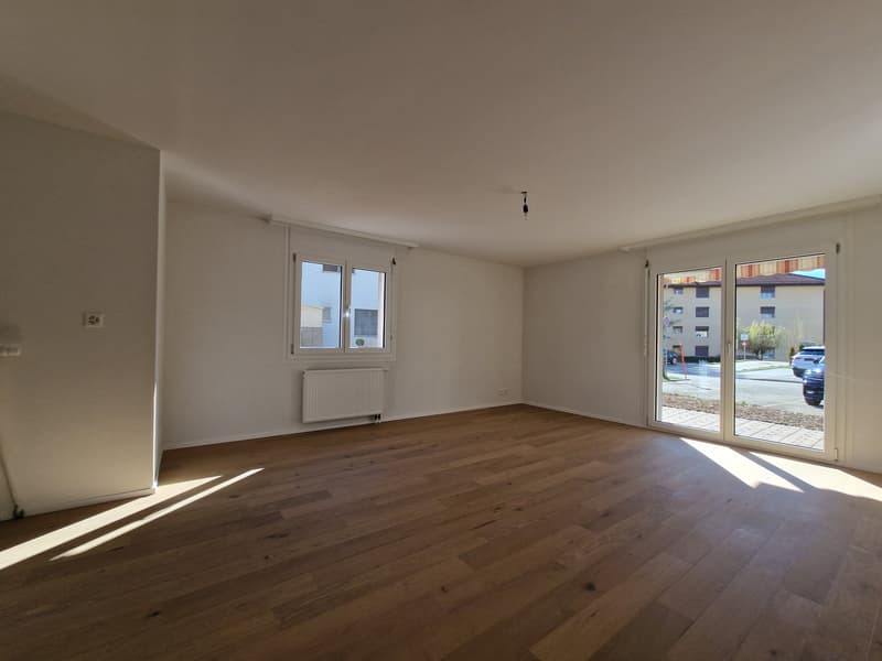 empty room, wooden floor, white walls, sliding glass doors, balcony, window, radiator