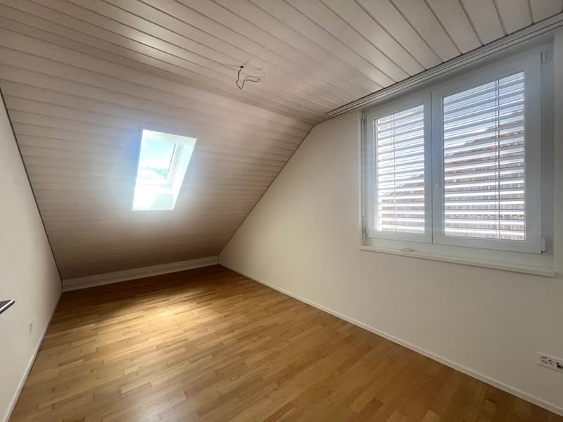 empty room, wooden floor, white walls, two windows, slanted ceiling