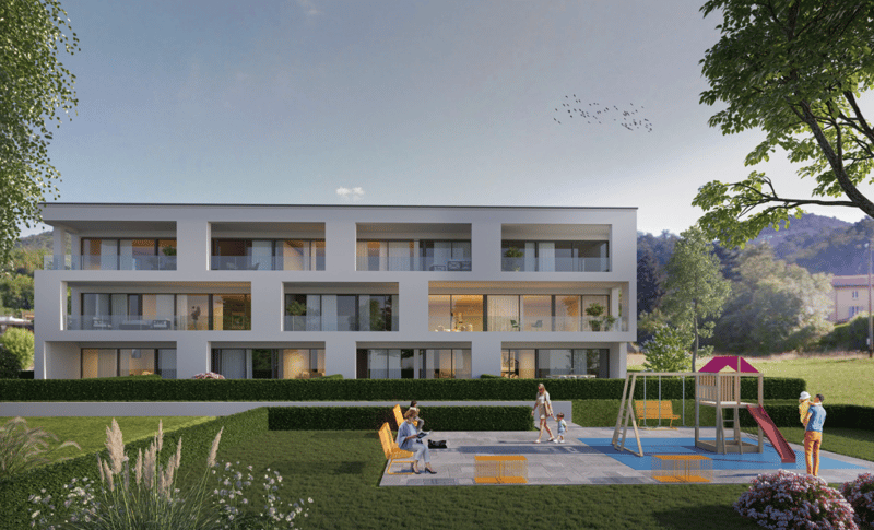3 story building, white exterior, glass windows, balconies, grass, play area