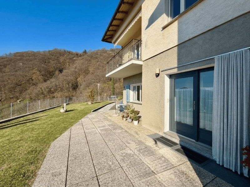 2 story house, balcony, paved walkway, garden, fence, plants