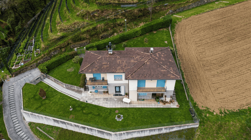 2 story house, brown roof, white walls, balcony, garden, driveway