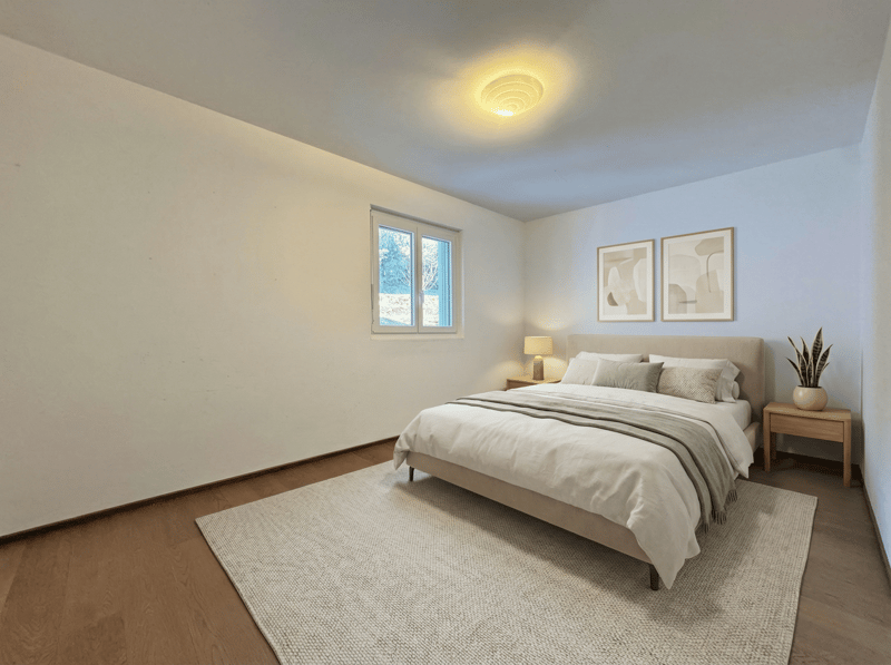 Bedroom with bed, nightstands, lamp, rug, and framed pictures on the wall