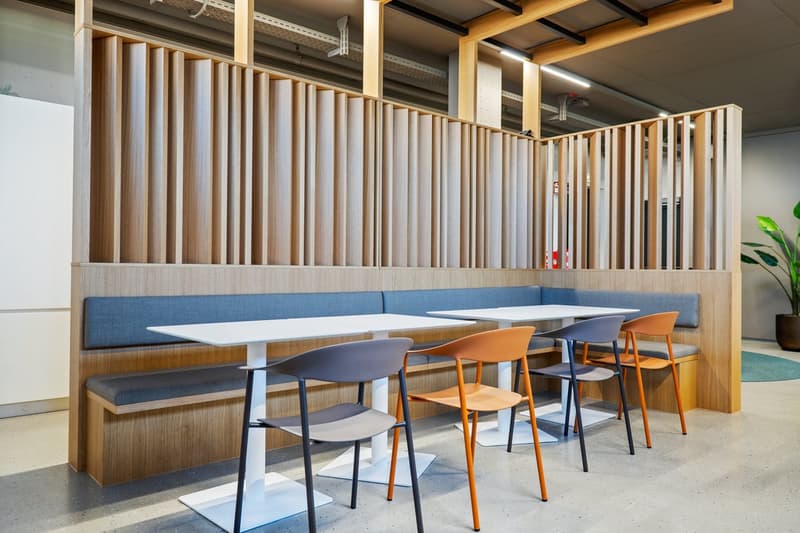 Wooden benches, white tables, colorful chairs, modern interior design