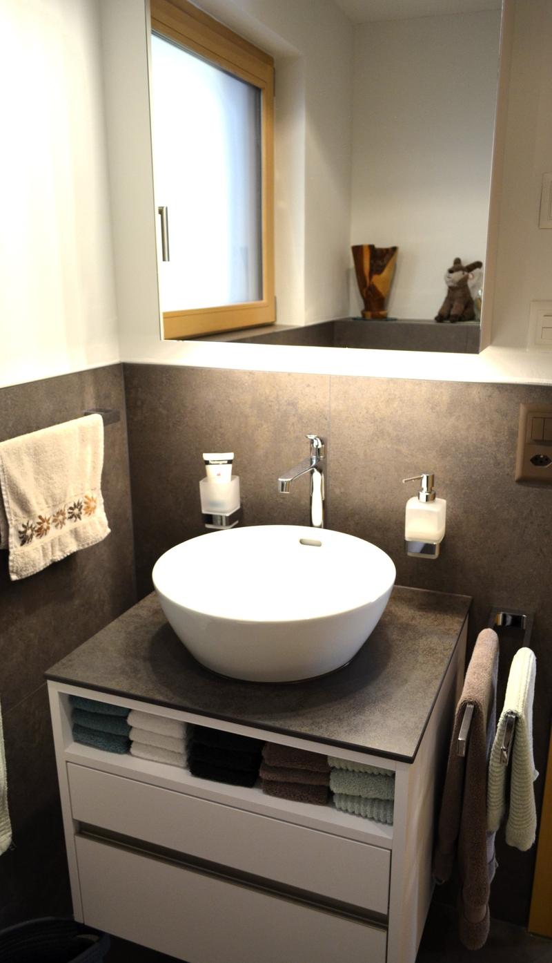 modern bathroom, white sink, grey countertop, storage, towel rack, mirror, grey tiles