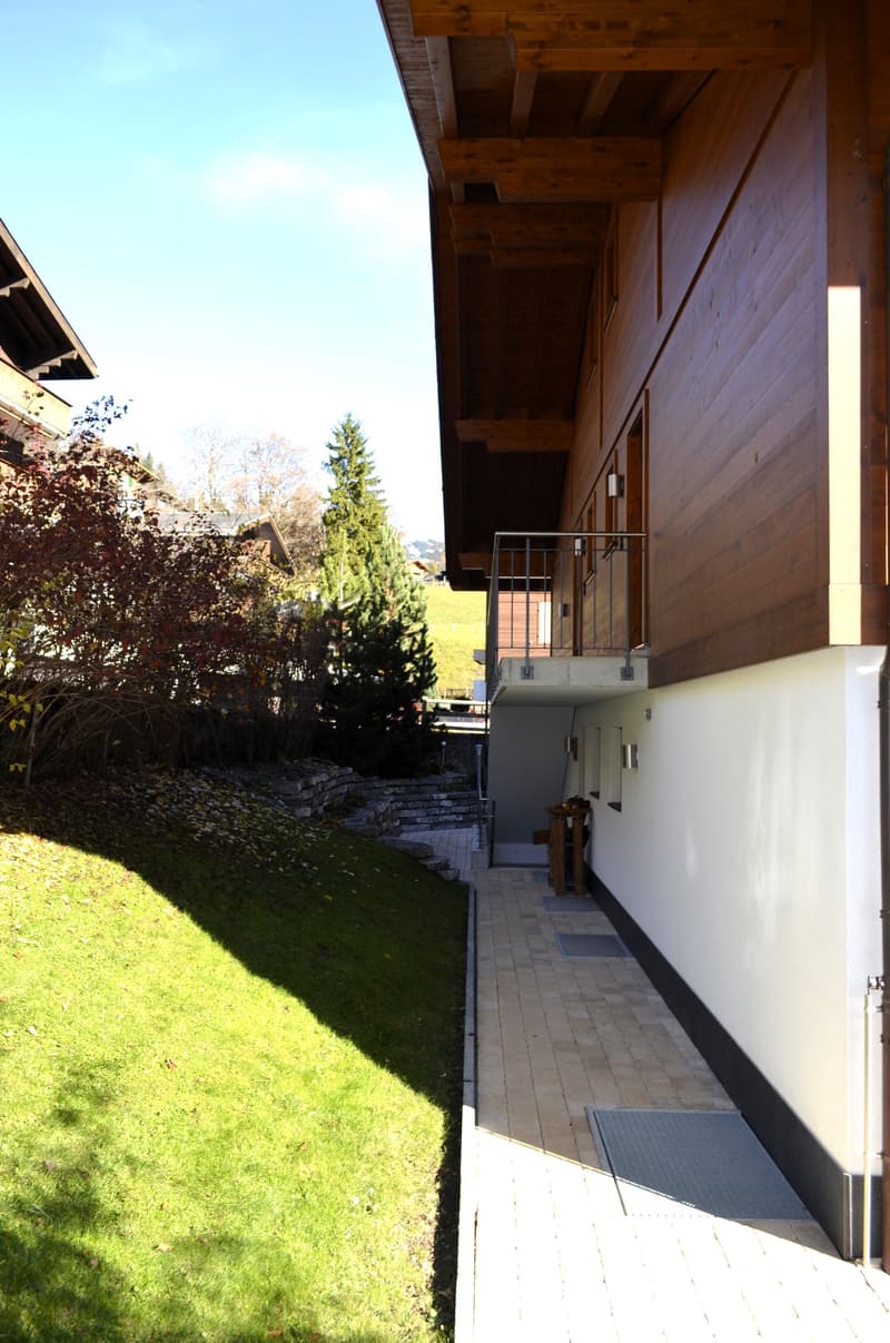 Facade of a wooden house with a balcony on the second floor