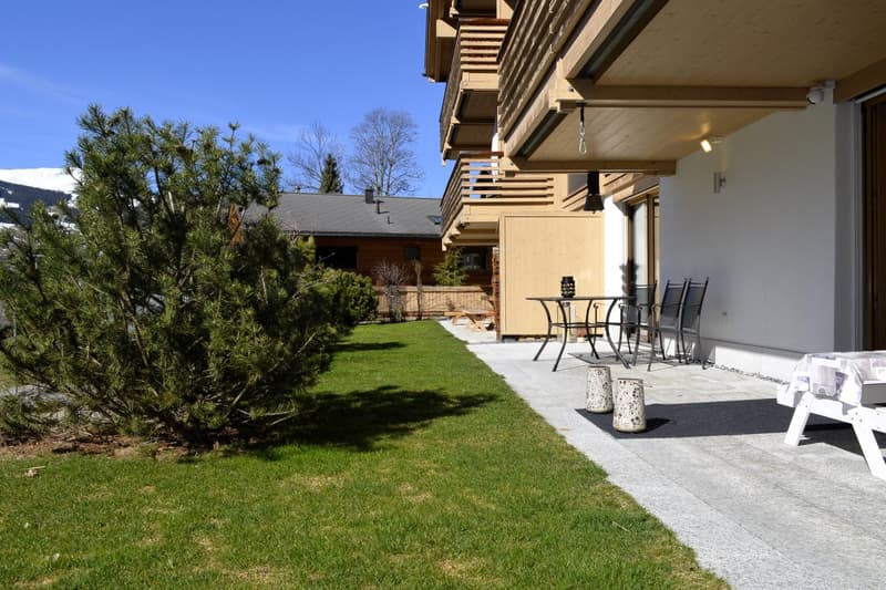 wooden exterior, balcony, outdoor table and chairs, well-maintained lawn, outdoor seating area