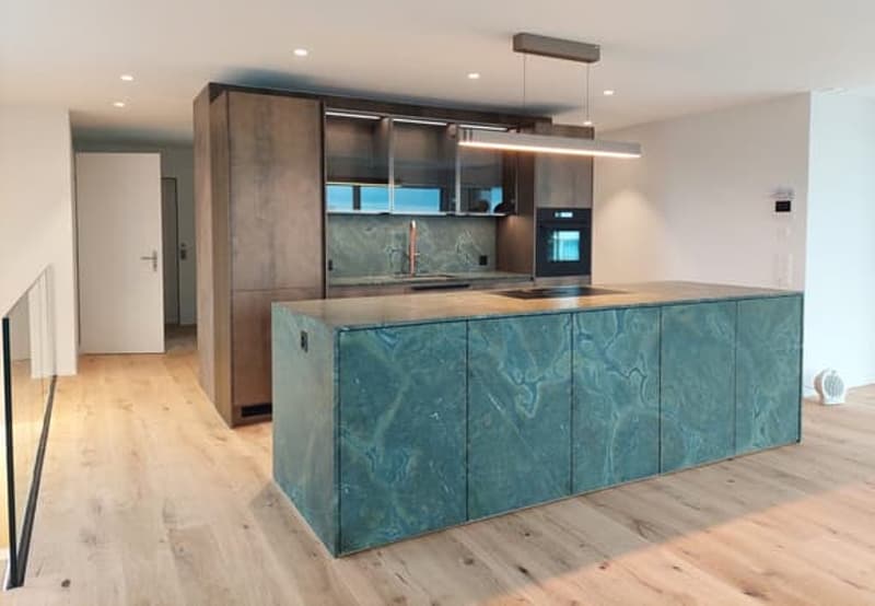 modern kitchen with island, wooden floor, green marble countertop, wooden cabinets, modern appliances