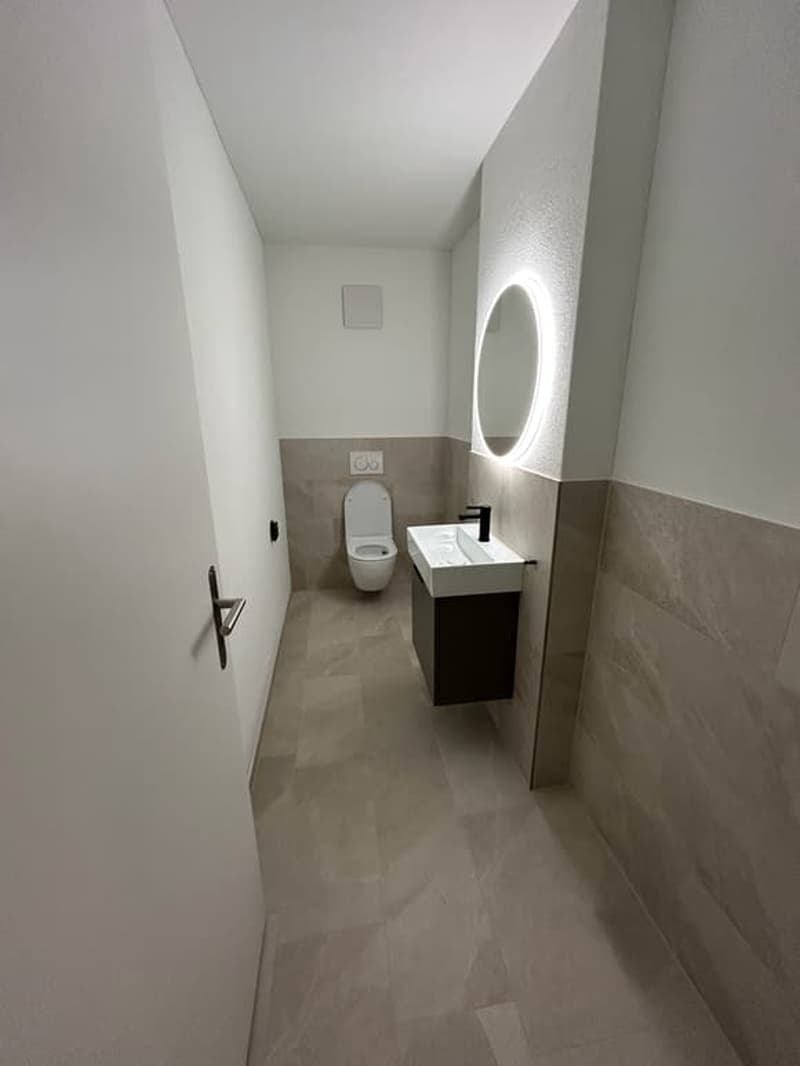 small bathroom with toilet, sink, and mirror