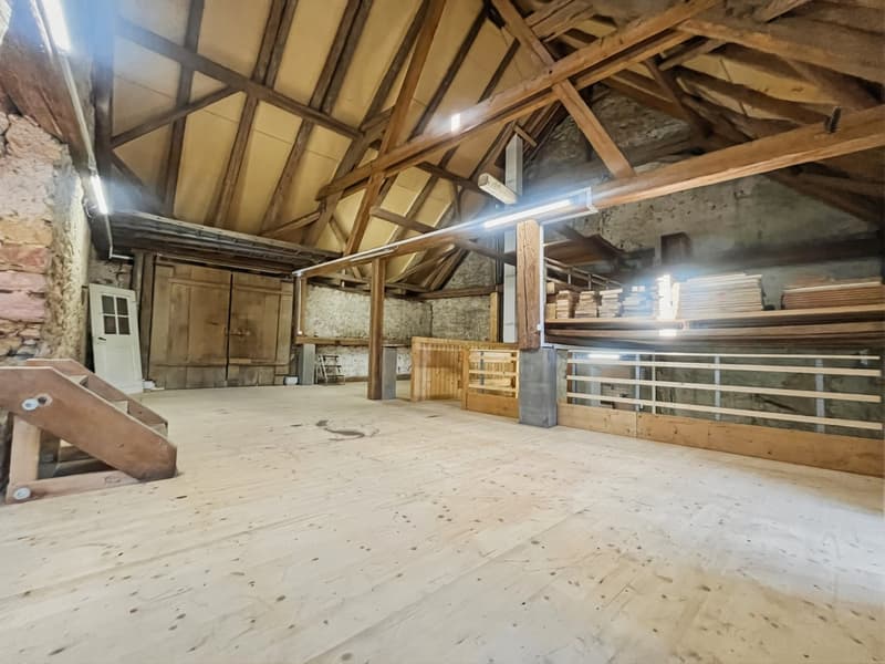 wooden trusses, wide space, stone walls, wooden floor, open space