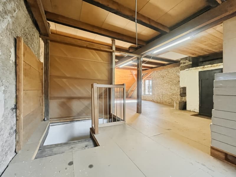 Stone walls, wooden beams, open area, hatchway